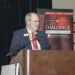 Dr. Van G. H. Clouse speaking at Cardinal Challenge podium