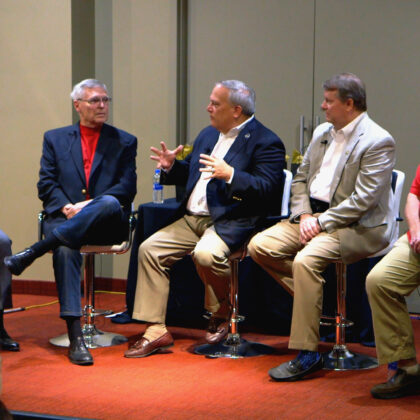 Five older businessmen discussing the state of the bourbon industry.