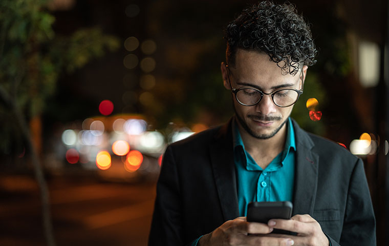 Business man using mobile at street