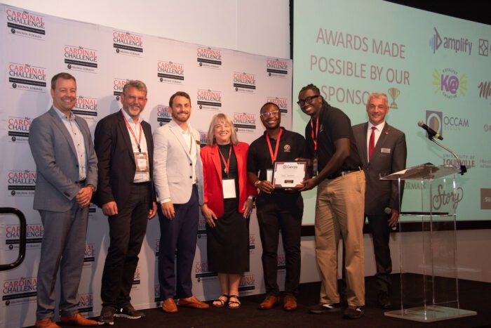 2025 Cardinal Challenge People's Choice winners, Golden Mashindi and Emmanuel Haynes, stand on stage holding an award