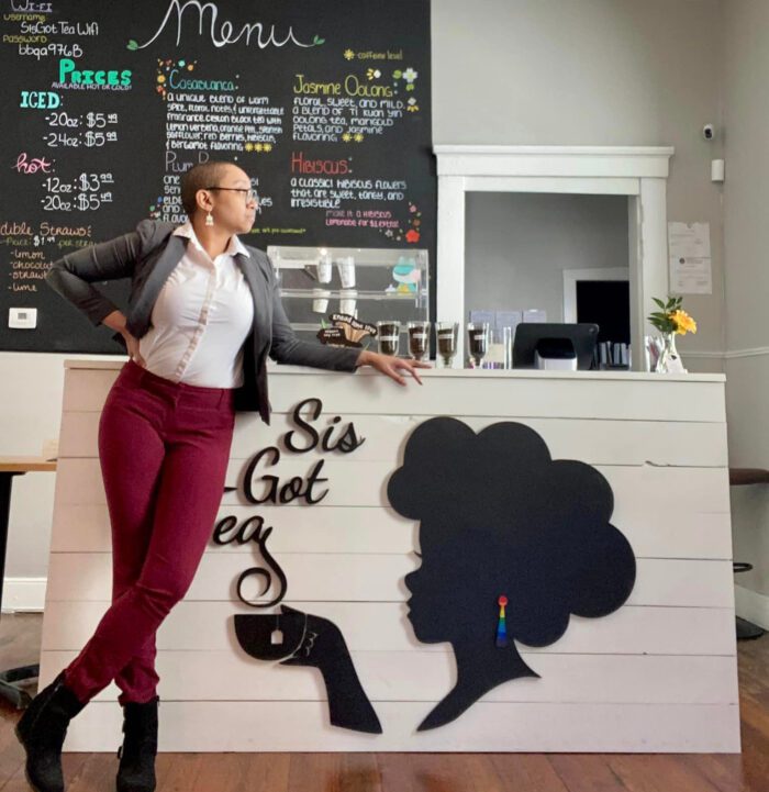 Arielle Clark stands in front of the counter of her cafe, Sis Got Tea.
