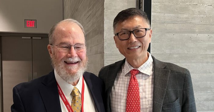 2024 Cardinal Challenge winner Van G. H. Clouse, PhD, stands beside College of Business Interim Dean Jeff Guan, PhD in the Speed Art Museum.