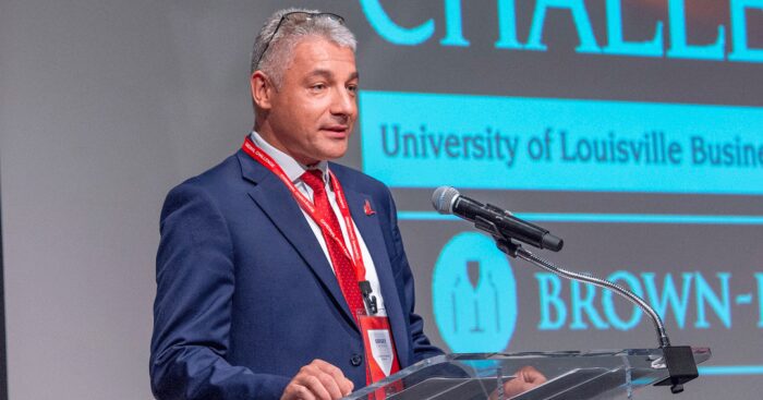 Sergey Anokhin, PhD, speaks to an audience on a stage in the Speed Art Museum.