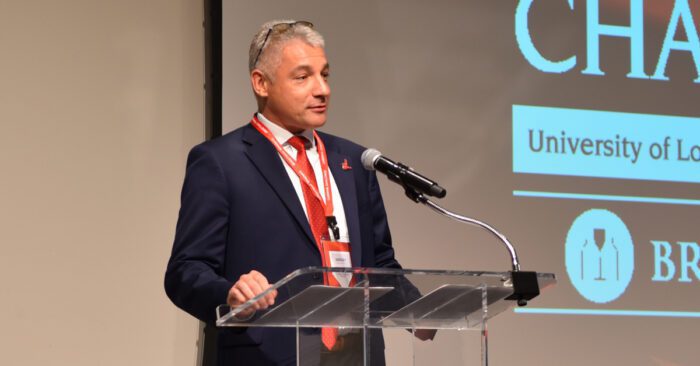 Director of the Forcht Center for Entrepreneurship Sergey Anokhin, PhD, presents on stage at the Speed Art Museum as part of the 2024 Cardinal Challenge.