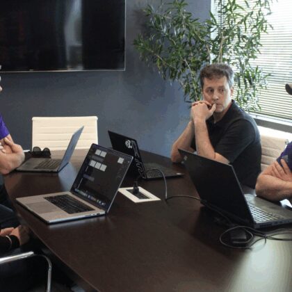 Slingshot staff discuss project around a conference table