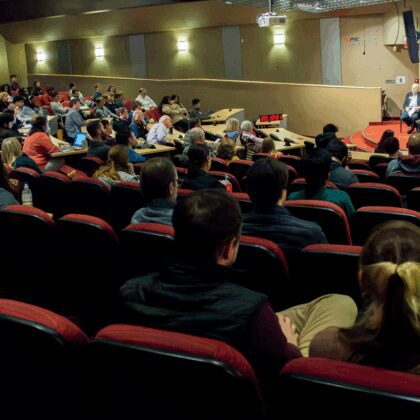 Guest speakers participate in a panel discussion in Horn Auditorium of Frazier Hall