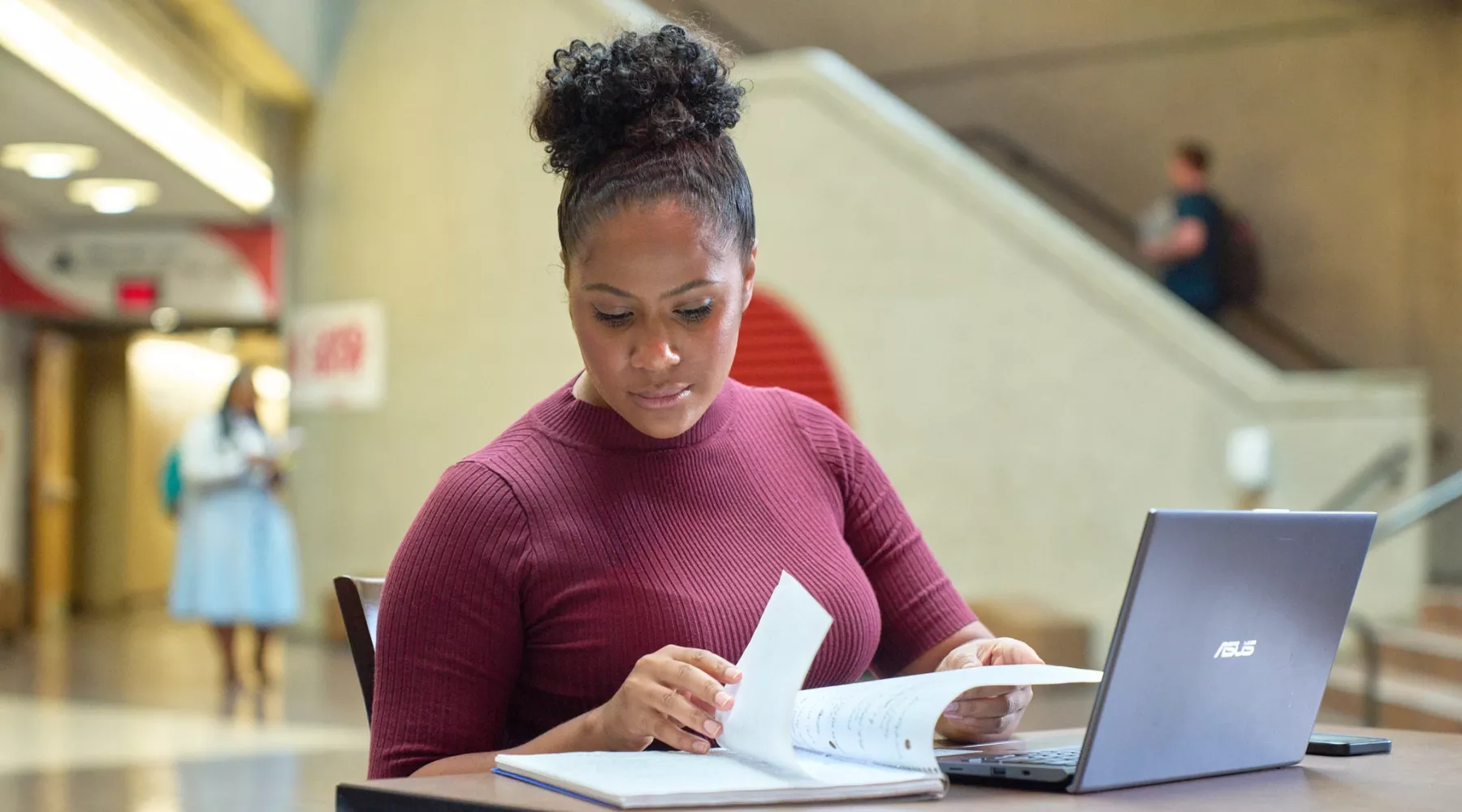 Female student studying academic materials in the college of business.