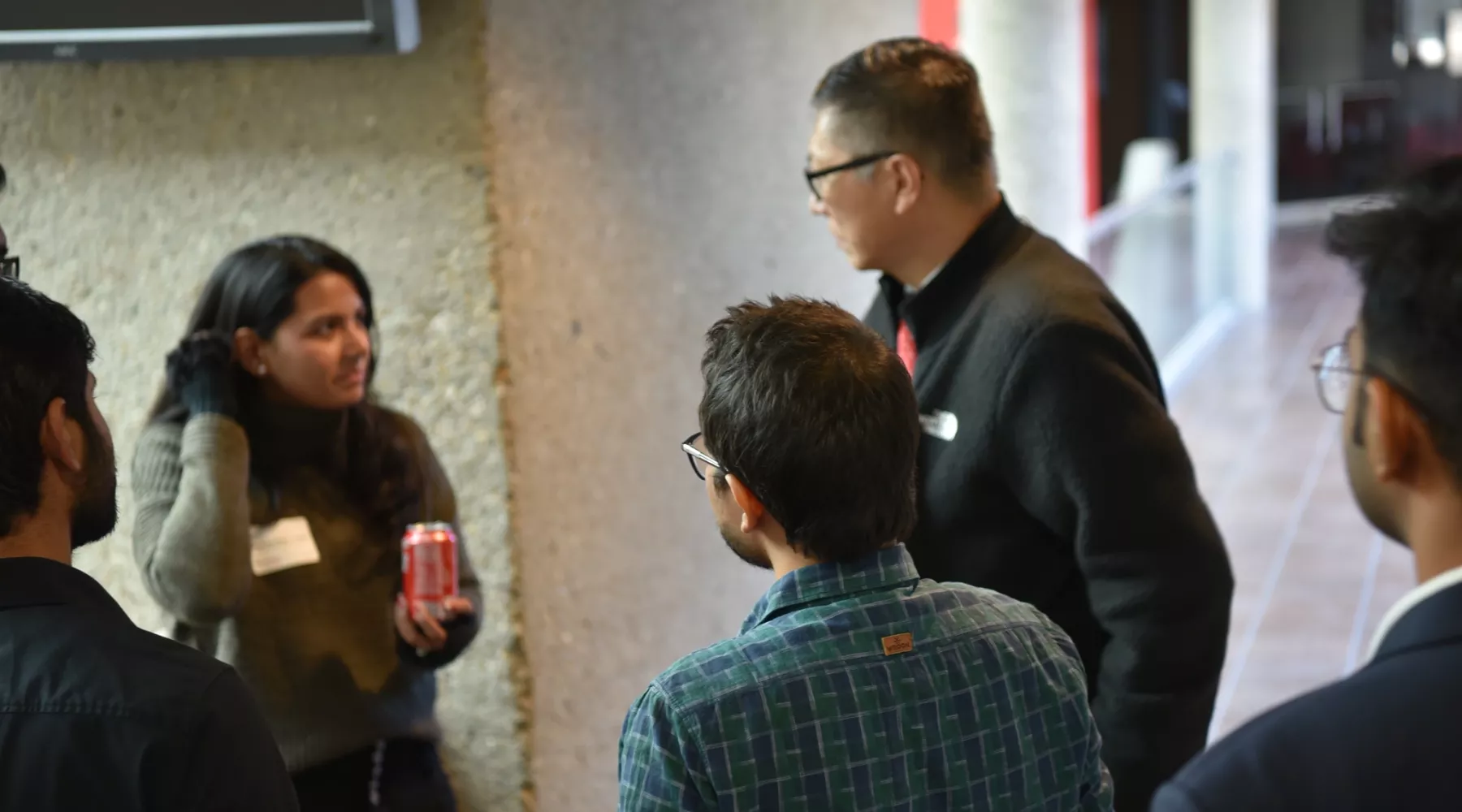 Interim Dean Jeff Guan surrounding by MSBA students having a discussion