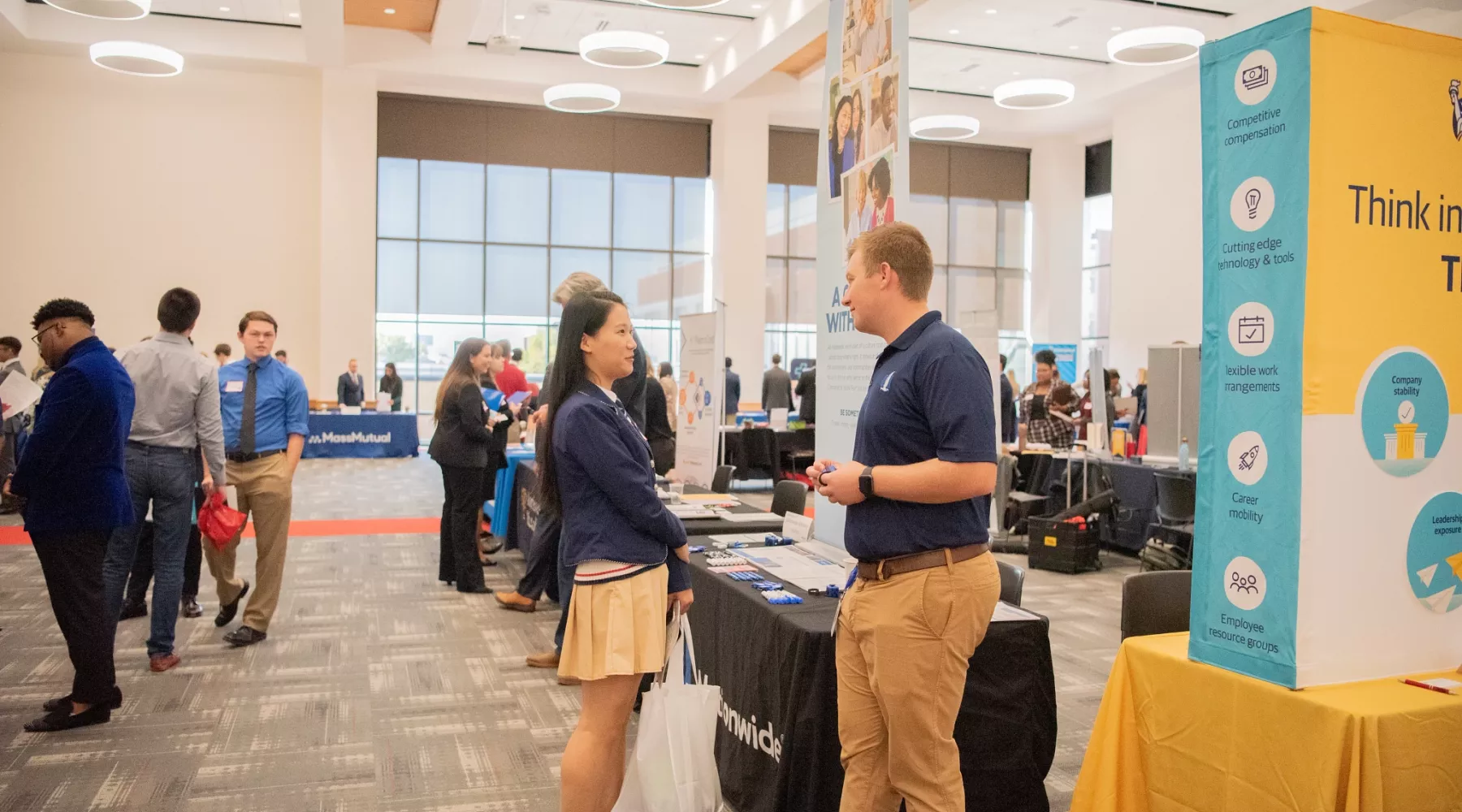 A female student and male recruiter engaging in conversation at COB Career Fair