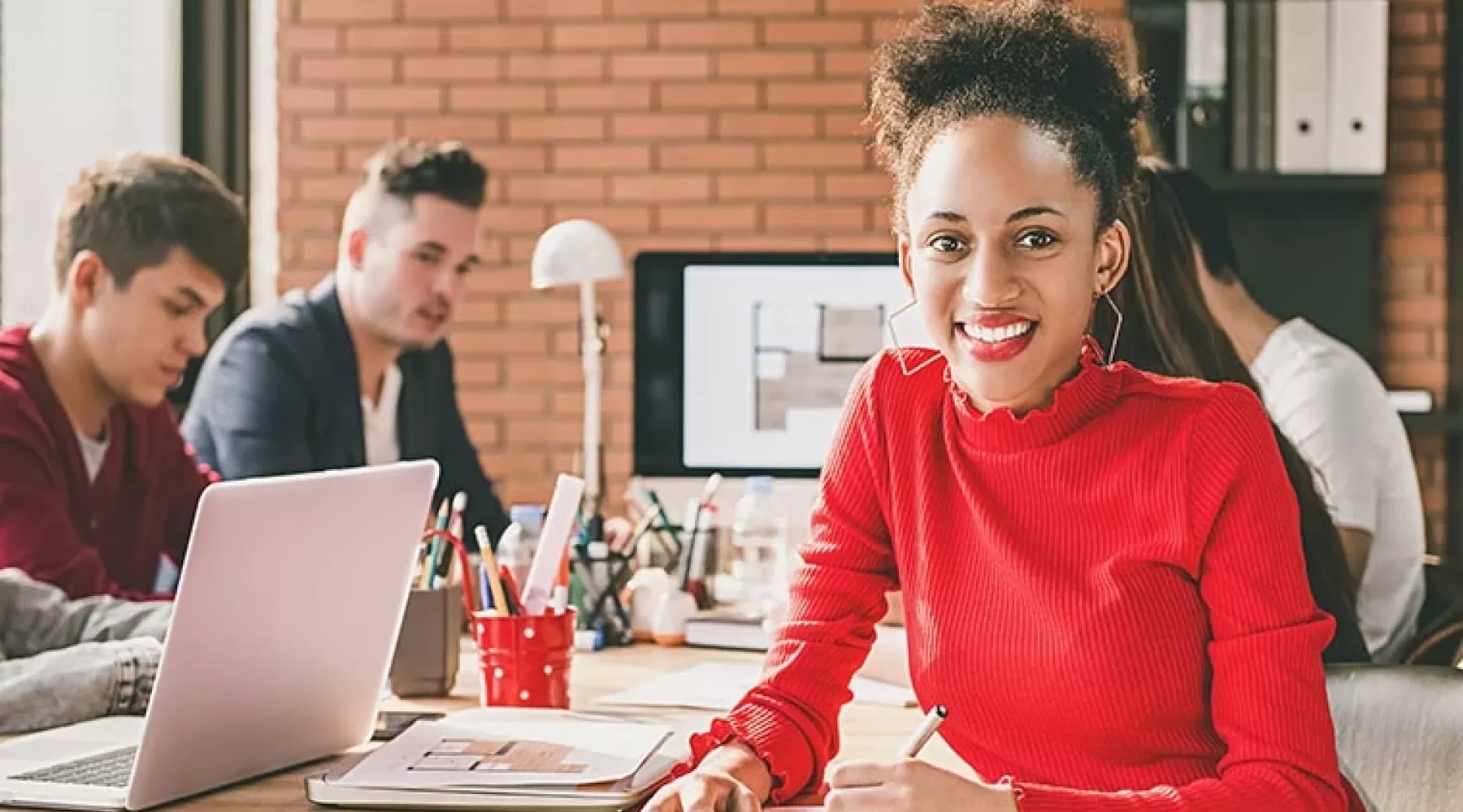 A young black businesswoman writing in her notebook
