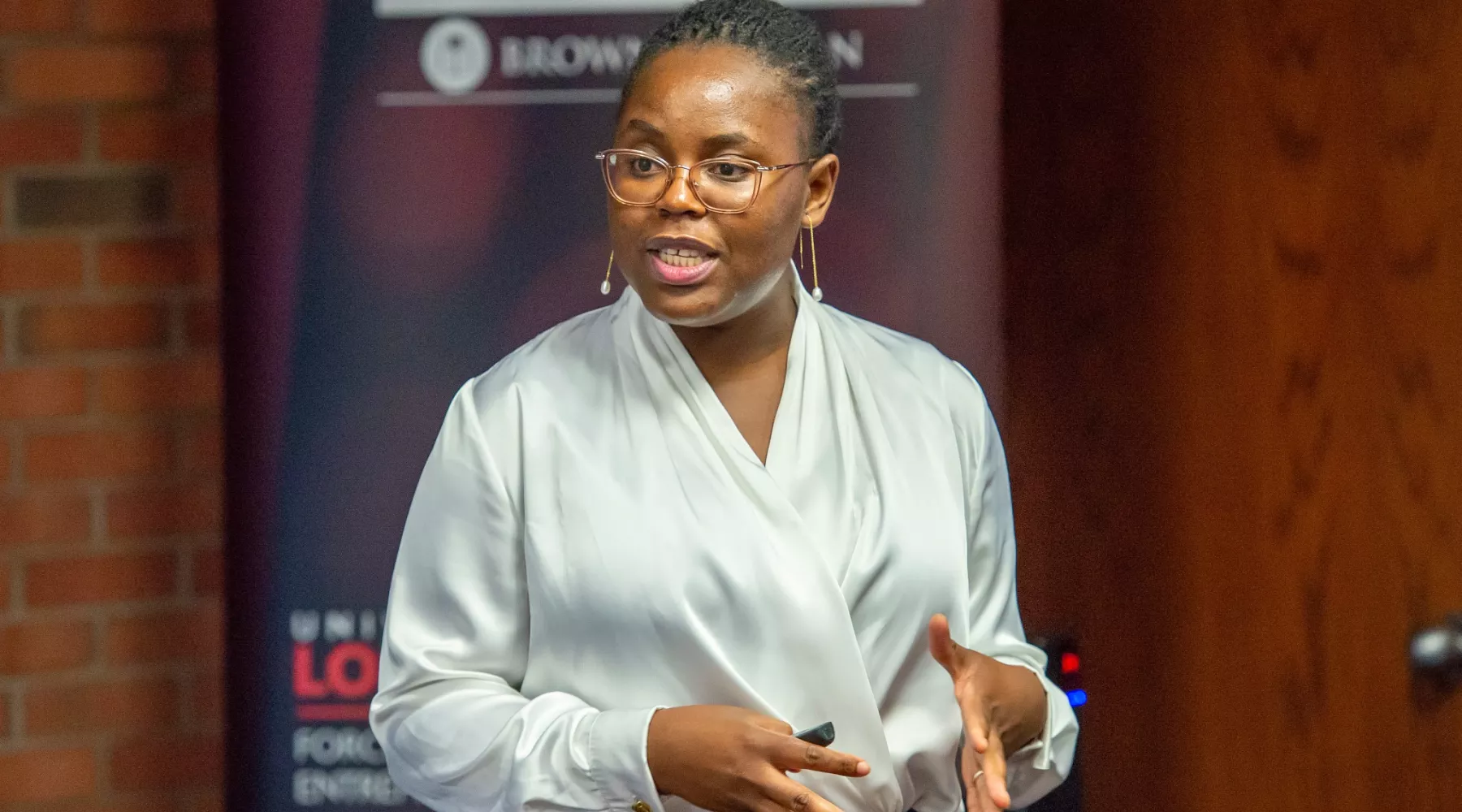 A member from a team presenting a startup idea to judges  at the Cardinal Challenge hosted by the Forcht Center for Entrepreneurship at the University of Louisville College of Business