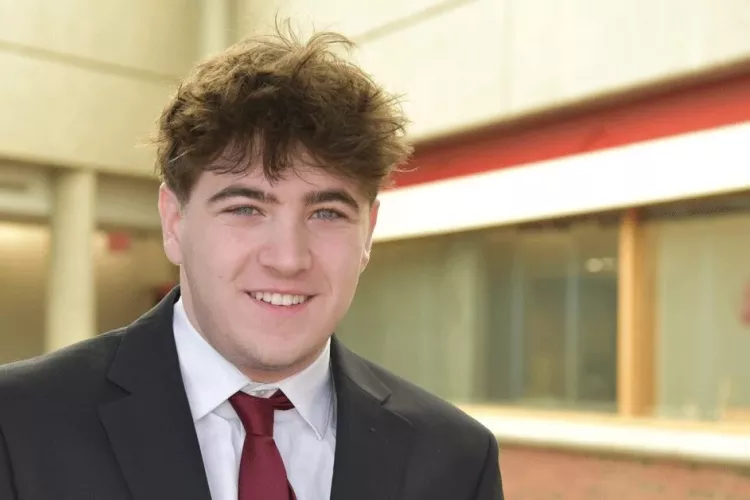 Headshot of a man smiling.