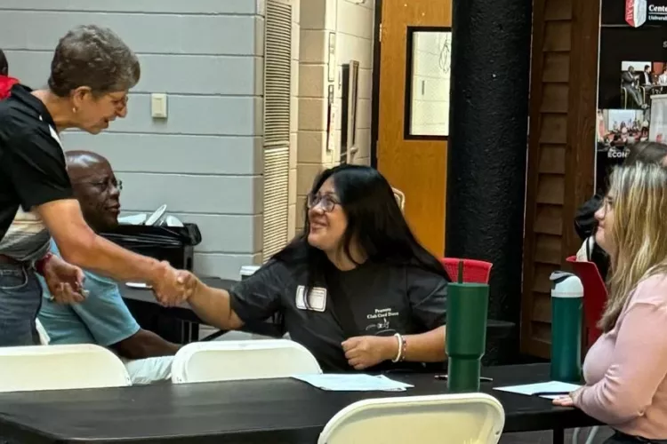 Professor Audrey Kline shaking a students hand