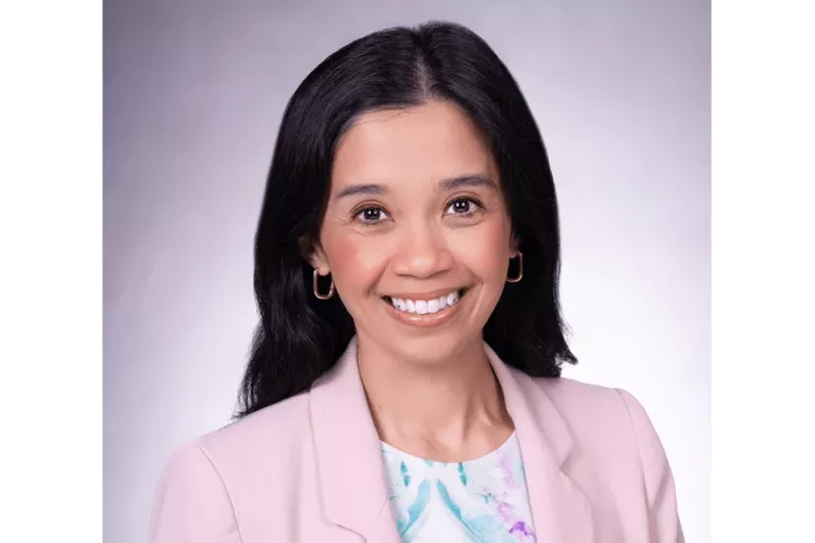 Kristina Cabanez in a pink blazer posing for headshot