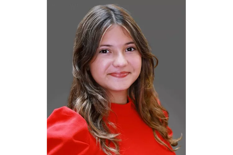 Mariana Meneses in red blouse posing for headshot