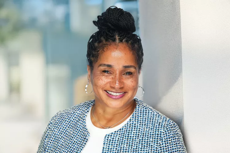 Woman in blue houndstooth blazer posing for headshot