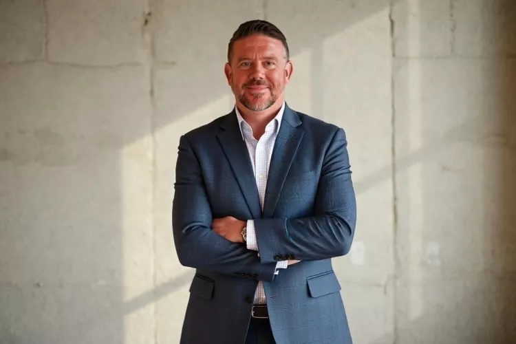 Larry Horn posing in navy suit