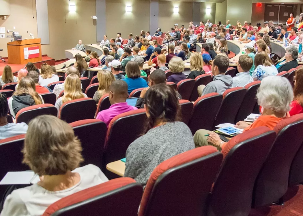 An attentative crowd listing to an Alumni presesnt in the Horn Auditorium