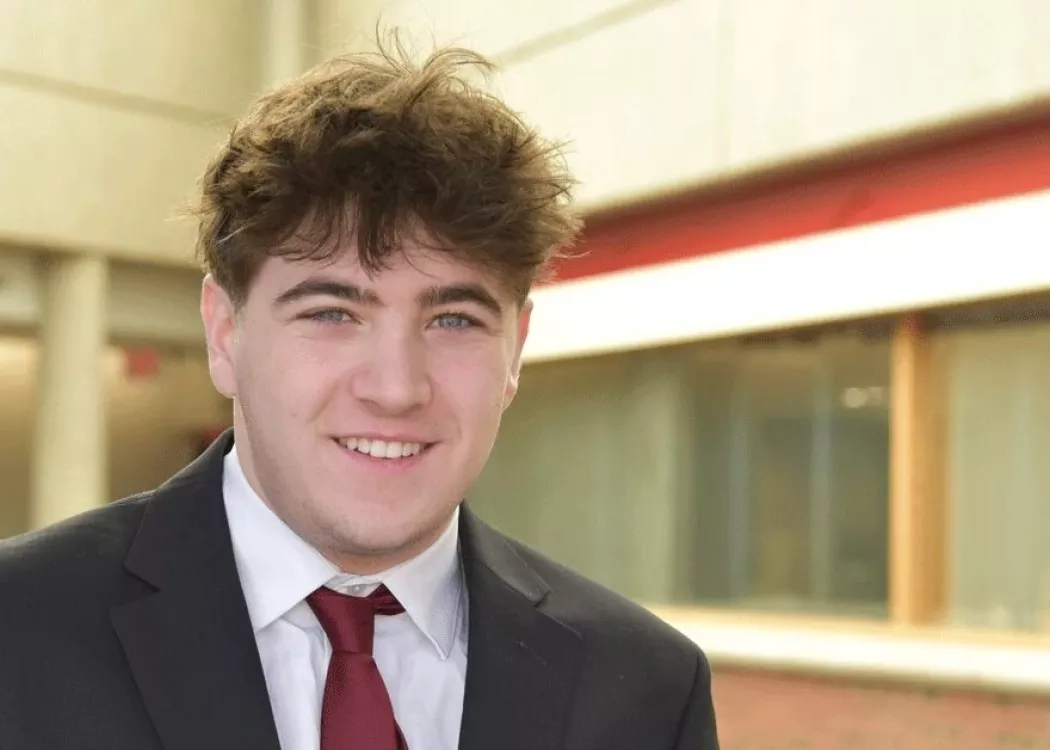 Headshot of a man smiling.