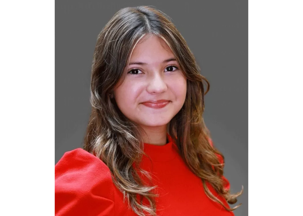 Mariana Meneses in red blouse posing for headshot