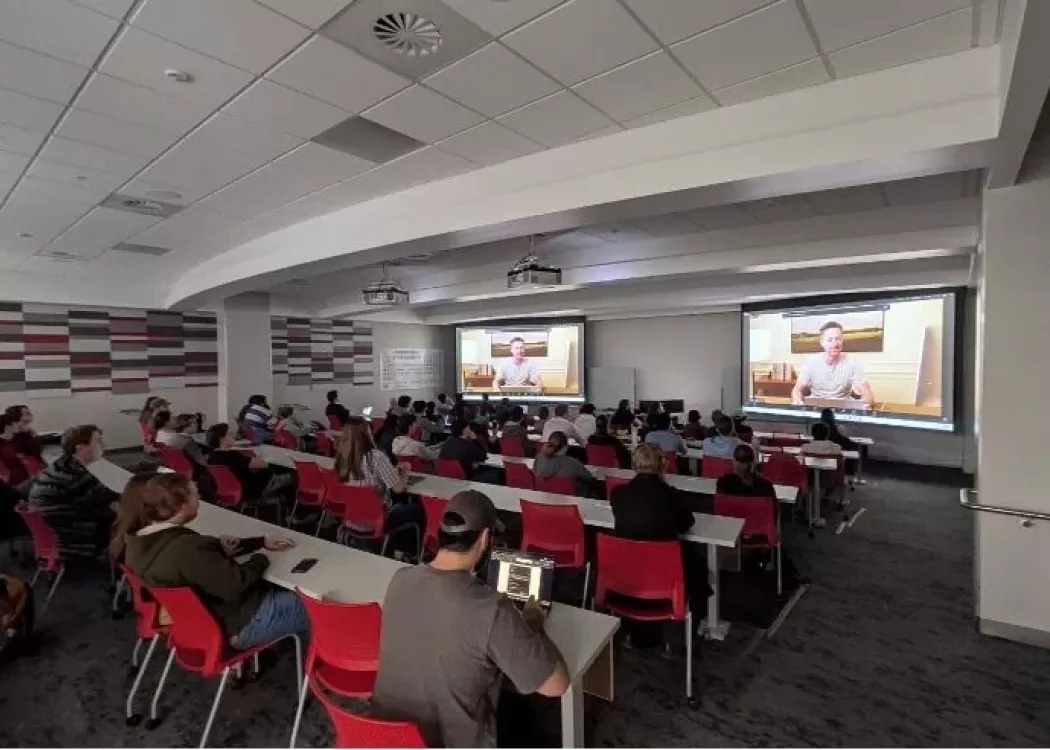 Group sitting in classroom watching presentation