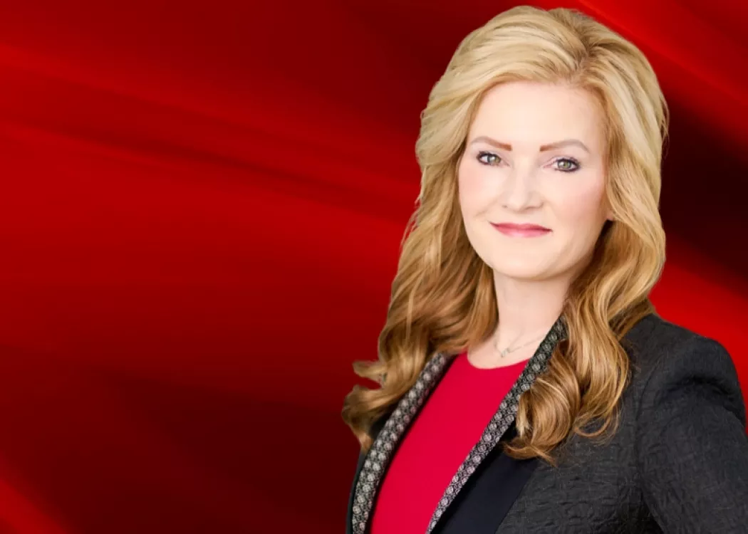 Woman in blazer on red graphic background