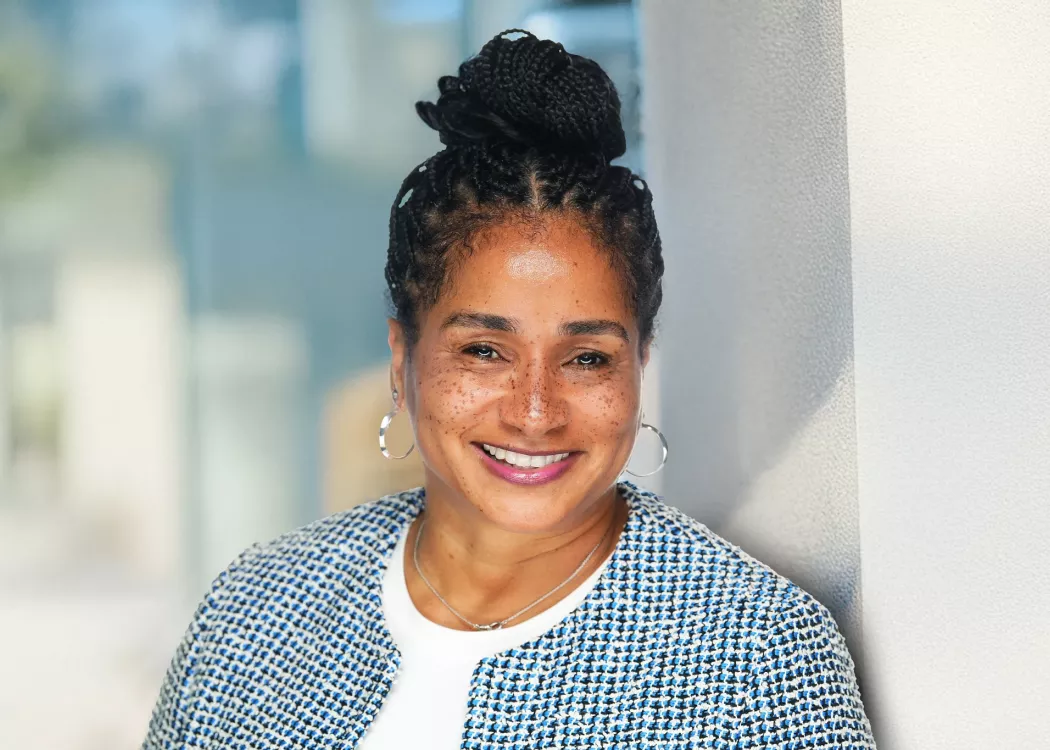 Woman in blue houndstooth blazer posing for headshot