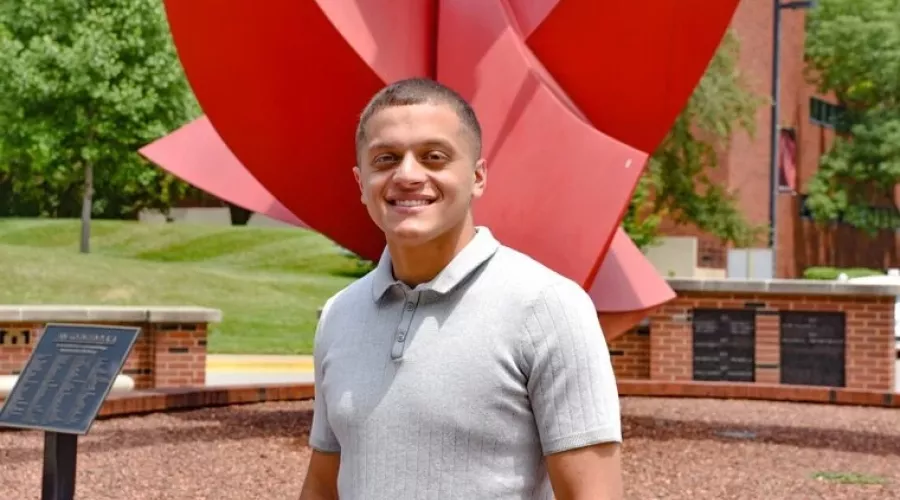 MSAA student, Abdul Alwan, Fall 2022 Cohort President for the Master of Science in Accounting & Analytics (MSAA) program standing in front of the College of Business Big Red statue.