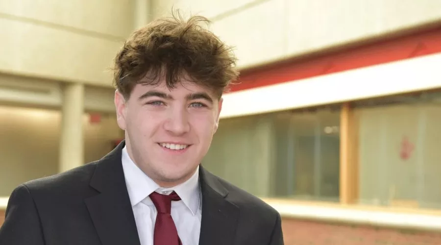 Headshot of a man smiling.