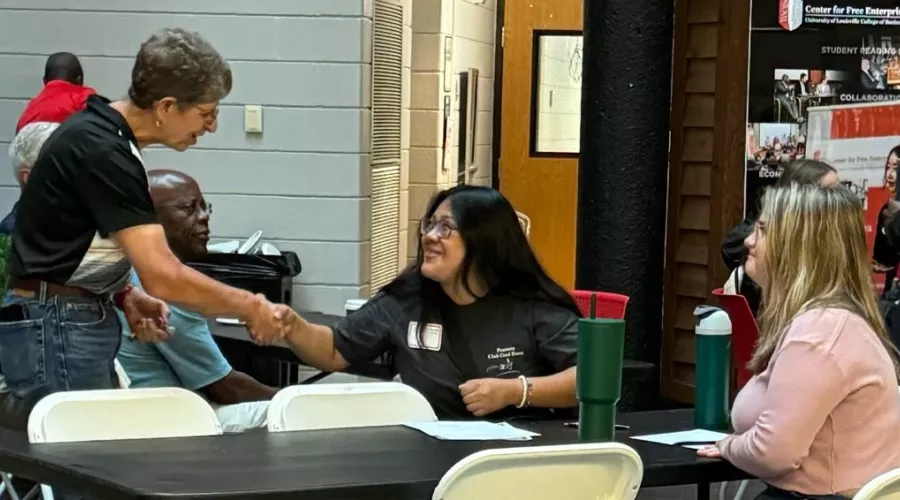 Professor Audrey Kline shaking a students hand