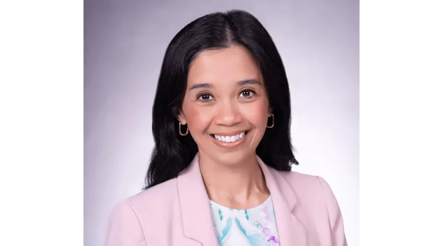 Kristina Cabanez in a pink blazer posing for headshot