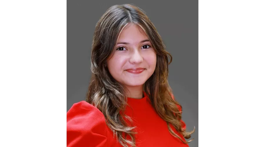 Mariana Meneses in red blouse posing for headshot