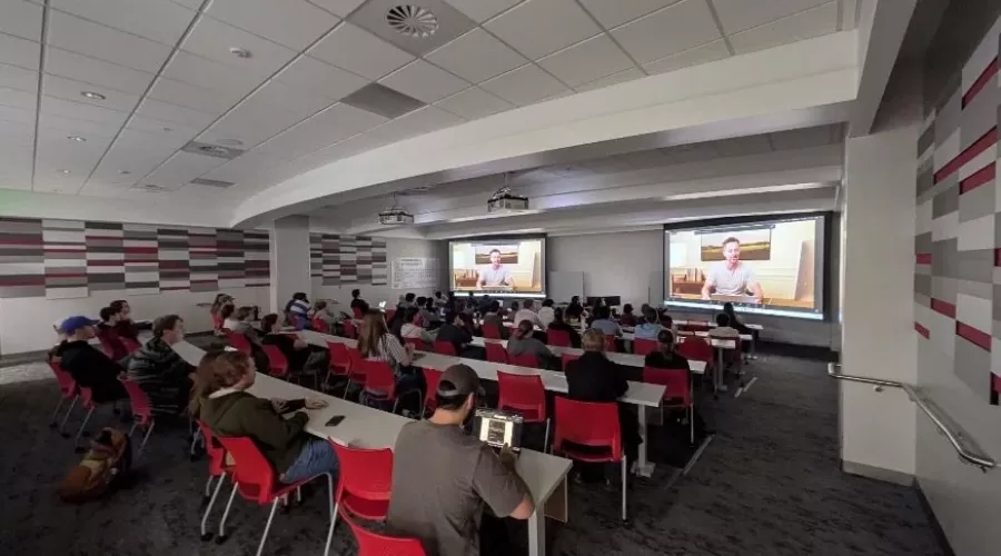 Group sitting in classroom watching presentation