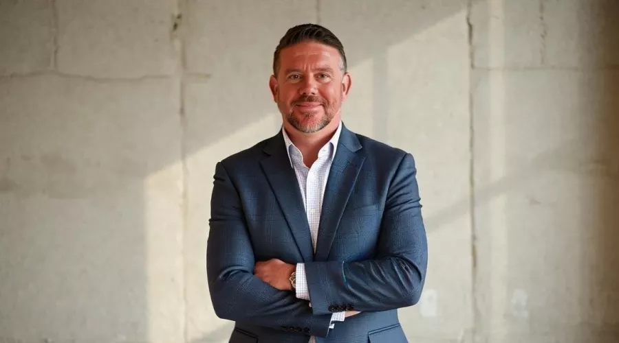 Larry Horn posing in navy suit