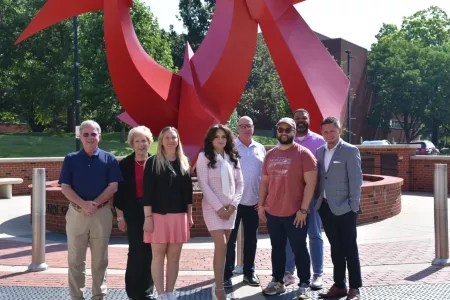 Accelerating Enterprise Growth participants stand in front of the Big Red statue with Kathy Gosser and Zac Goldman