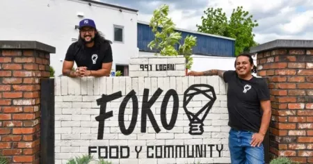 FOKO co-owners Joshua Gonzalez and Francisco Leonardo stand next to one of their signs at 991 Logan Street
